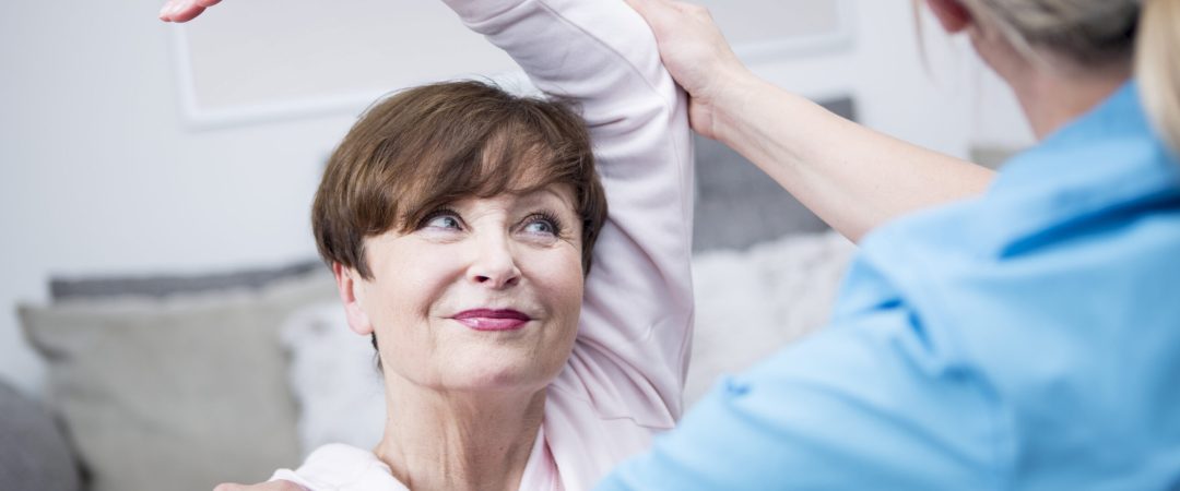 Gereatric nurse doing physio therapy with patient