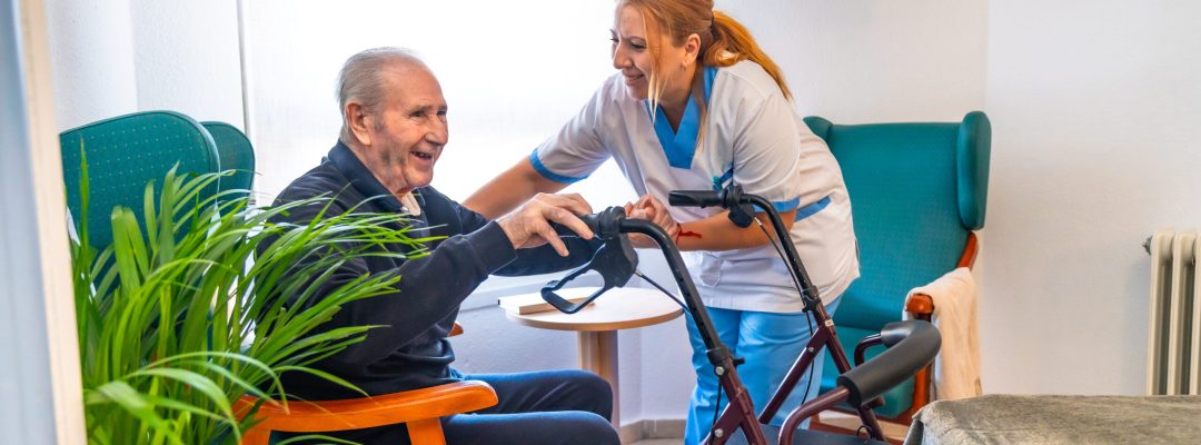 Physiotherapist assisting a senior man to stand up.